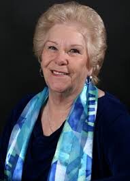 A Woman in a Black Color Top in a Blue Shaded Scarf Image